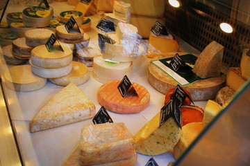 French cheese inside an exhibitor in a market.