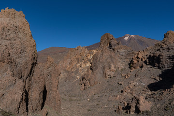 Fototapeta na wymiar View of Roques de García unique rock formation with famous Pico del Teide mountain volcano summit in the background on a sunrise, Teide National Park, Tenerife, Canary Islands, Spain