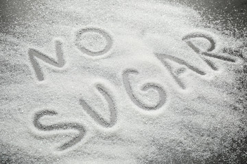Composition with phrase NO SUGAR on grey table