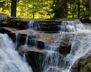Fototapeta na wymiar Szklarka Falls in super green forest surroundings, Karkonoski National Park, Poland