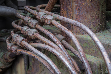 rusty hydraulic pipelines on a machine
