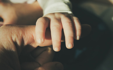 baby and father's hands