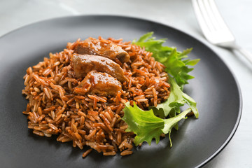 Tasty brown rice with meat on table, closeup