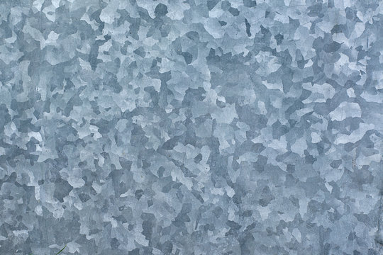 Galvanized sheet metal plate texture. Metal plate with galvanized coating and zinc contents. Corrosion resistant durable product for outdoor applications - roofing and construction applications.