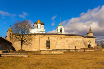 The view of the walls and towers of the medieval fortress is made on a clear spring day. Pskov, Russia.