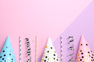Flat lay composition with birthday caps on color background. Space for text