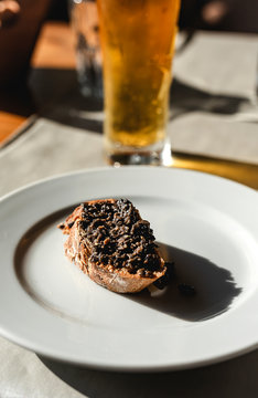 Open sandwich with brown sauce on plate