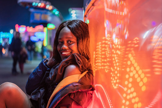 Cheerful black woman on funfair