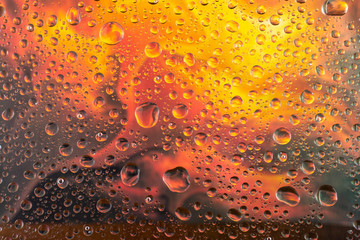 abstract water drop background on a beautiful orange background with reflection