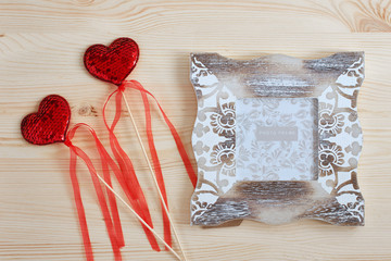Photo frame and decorative red hearts for Valentine's Day. Holiday card for lovers.