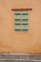 Window in the house closed by shutters