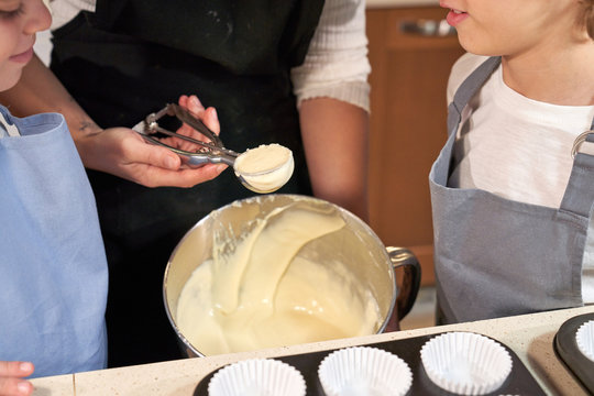 Stock photo of a detail of a hand removing cream with a portioned Ice cream scoops