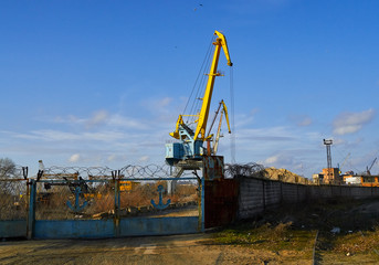 Fototapeta na wymiar two cranes stand on a pier in the port