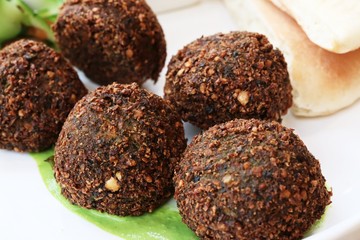 Falafel balls on white background with peppermint leaves for garnish