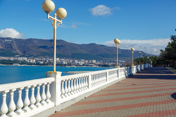 Gelendzhik embankment in the early morning. The balustrade goes into the distance. Caucasus mountains on the opposite side of the Bay