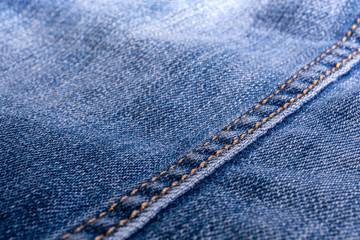 Jeans texture. Denim. The seam on the fabric. light industry. Street youth fashion style.