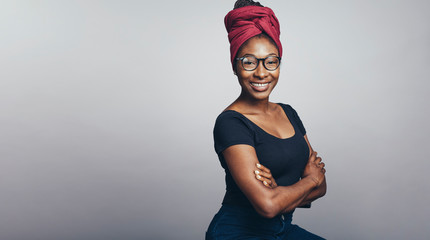 Smiling african woman in a headwrap - obrazy, fototapety, plakaty
