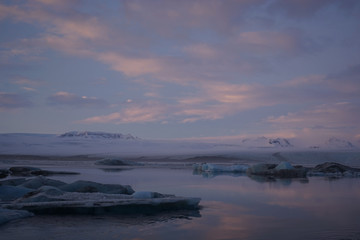 Sunset at the Glacier lagoon, Iceland. Pink clouds and ice, winter 