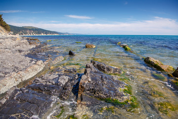 Fototapeta na wymiar Rocks with a black hue on the black sea coast on a clear Sunny day