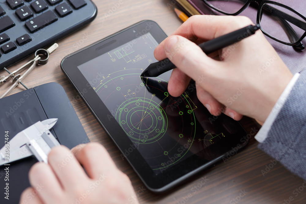 Poster engineer working on tablet computer. designer working on a drawing of cad scheme.