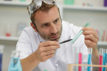 scientist man working holding medical chemicals sample