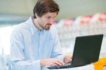 young man using laptop in workplace