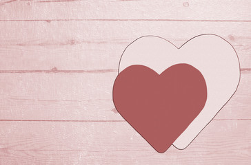 Hearts on a textured wooden background. Tinted in pink
