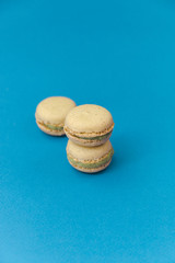 Pistachio Macaroons on turquoise background top, colorful macaroons, selective focus