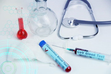 medical laboratory test tube with the word coronavirus test on glass and blood inside, stethoscope,...