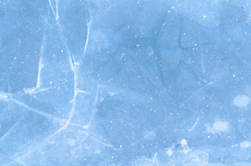 blue ice background. Ice is cracking creating a beautiful composition of lines