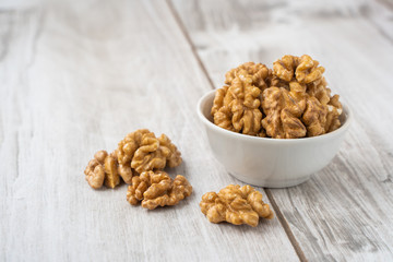 Walnut in the white bowl on wood table