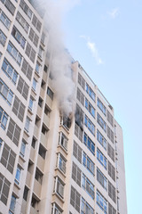 Smoke coming from the apartment of a tall building