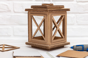 Craft cardboard lantern in work © Volha