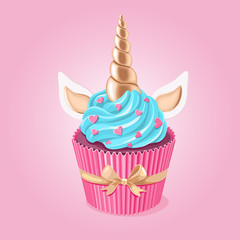 Festive unicorn cupcake.  Cake with golden horn and cream on pink background