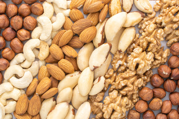 Different nuts in the row on the table, stock photo.