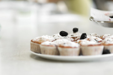 Plate with freshly baked sweet muffins. Sweet pastries, recipes, cooking