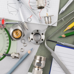Abstract engineering and technology background featuring details of researcher table with...