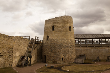 The panorama of the medieval fortress was made on a cloudy spring day. Izborsk, Pskov Region, Russia.