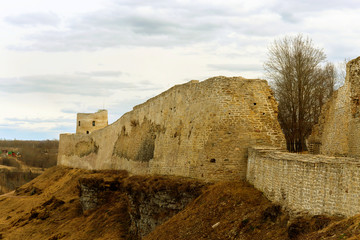 The panorama of the medieval fortress was made on a cloudy spring day. Izborsk, Pskov Region,...