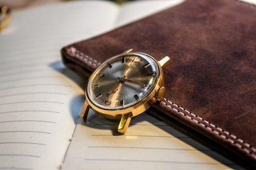 vintage watch on leather wallet