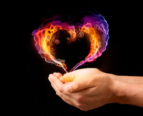 Fiery heart in the hands. Valentines day concept