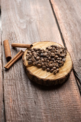 Coffee beans in the form of a heart on a wooden vintage background, the concept of love on Valentine's day