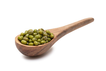 Brown wooden spoon with mung beans seen obliquely from the front and isolated on white background
