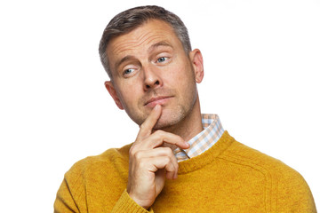 middle aged man in thought with finger on chin