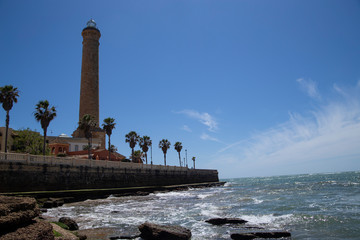 Obraz premium lighthouse on the shore of the Mediterranean in the summer in sunny weather