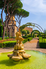 Rome, Vatican City, Italy - Alleys and fountains of French Garden section of the Vatican Gardens in the Vatican City State with Vatican Radio broadcasting tower in the background