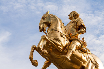Baroque equestrian statue ("Goldene Reitter") in Dresden (Germany) with a blue sky with clouds in background