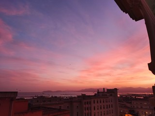 Panorama colorful magnificent sunset overlooking the harbor in Cagliari City, Italy