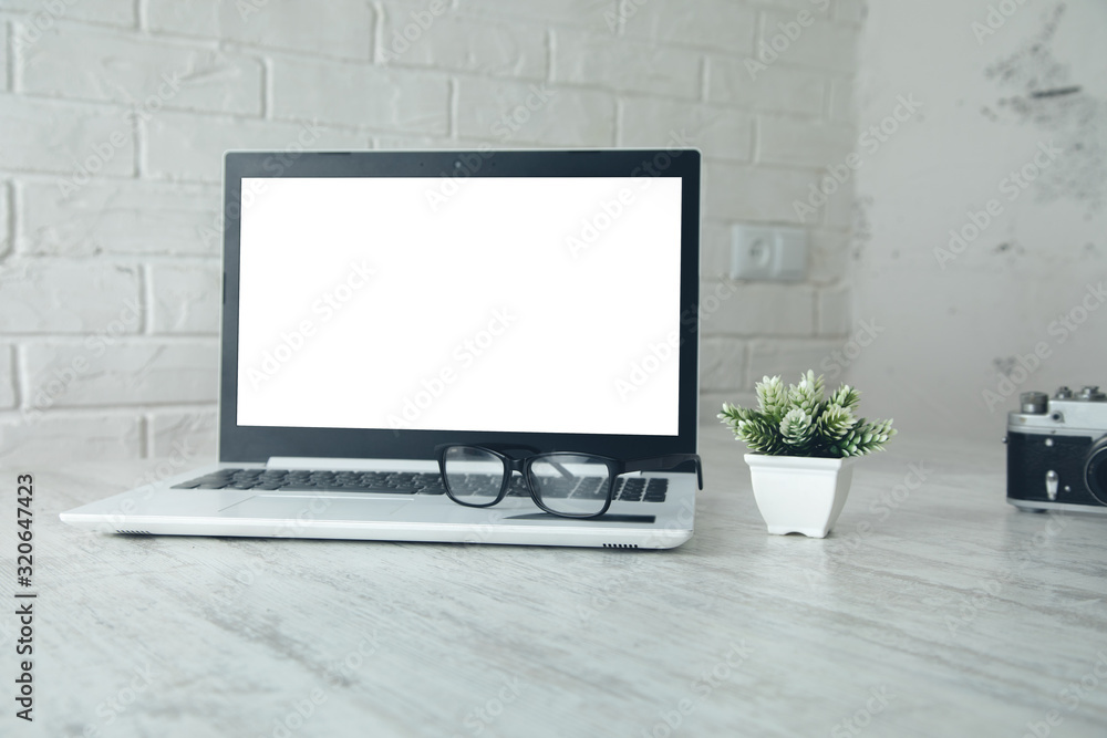 Poster camera with glasses and computer on desk