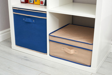 The drawer is divided into cells of different sizes, for separate storage of linen and fabrics. Home storage system for storing clothes. Folding boxes in a set have different shapes.